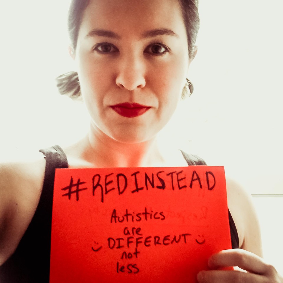 ashia holding #redinstead sign for autism acceptance