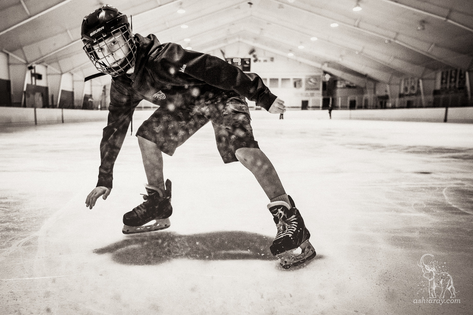 Boy shaving ice on hockey skates